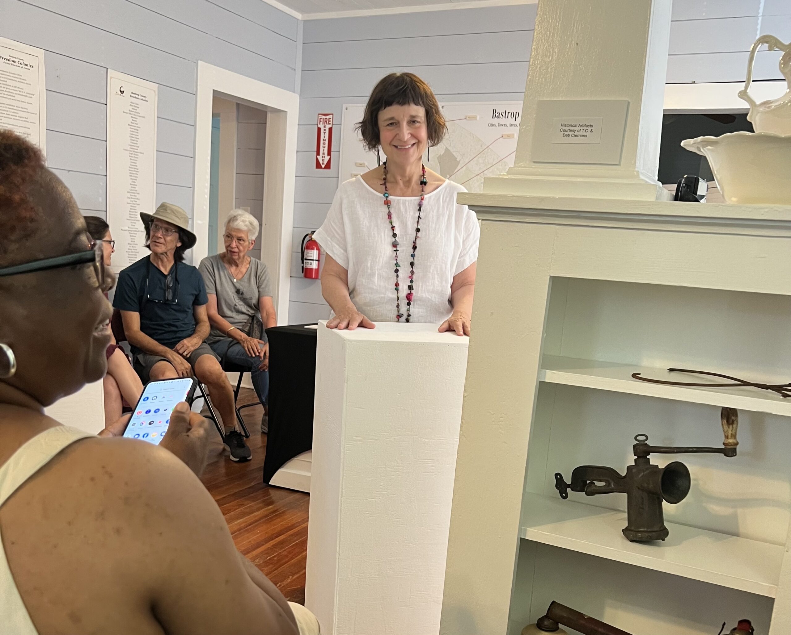 Woman speaking at podium to seated audience