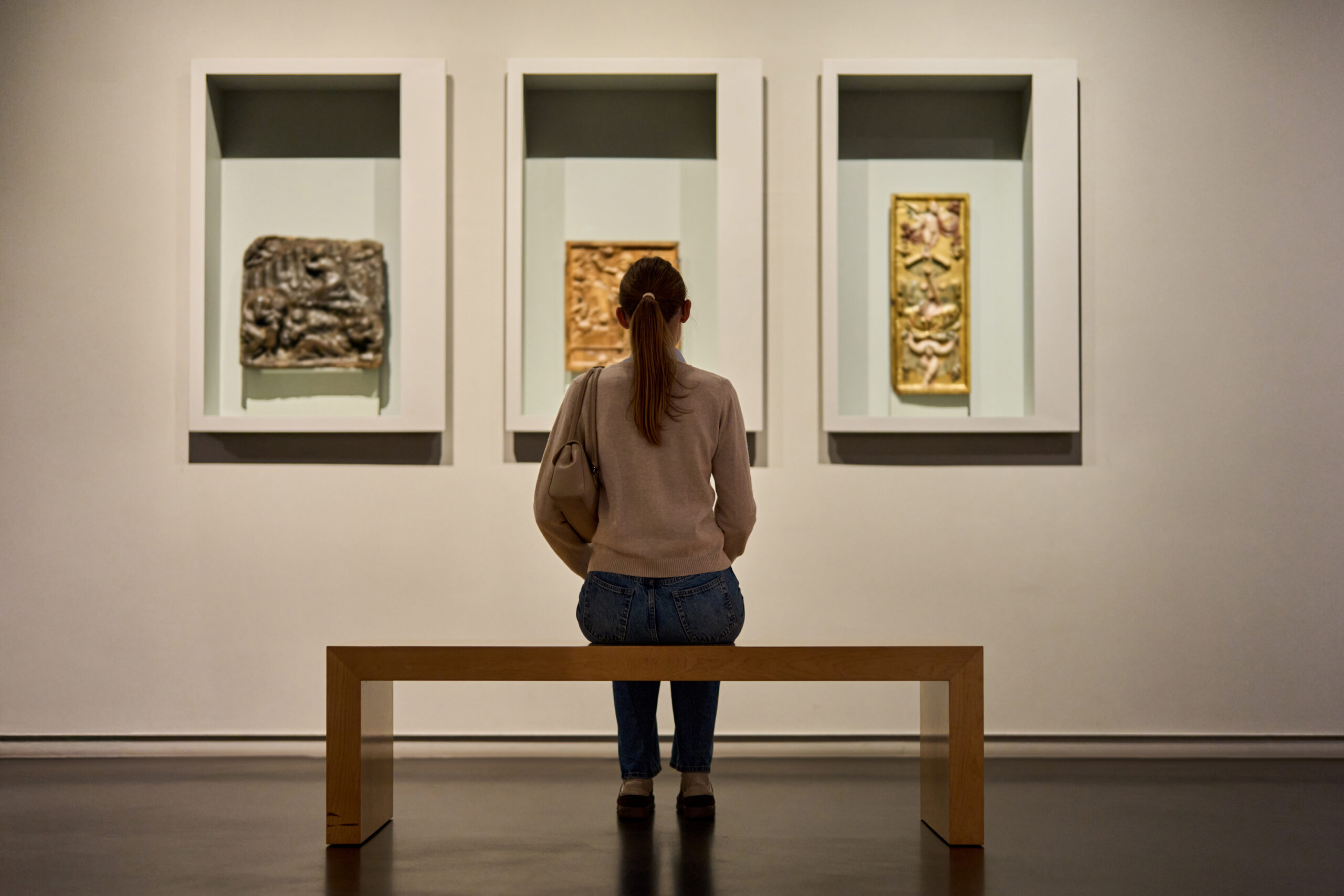 Visitor admiring framed artwork display