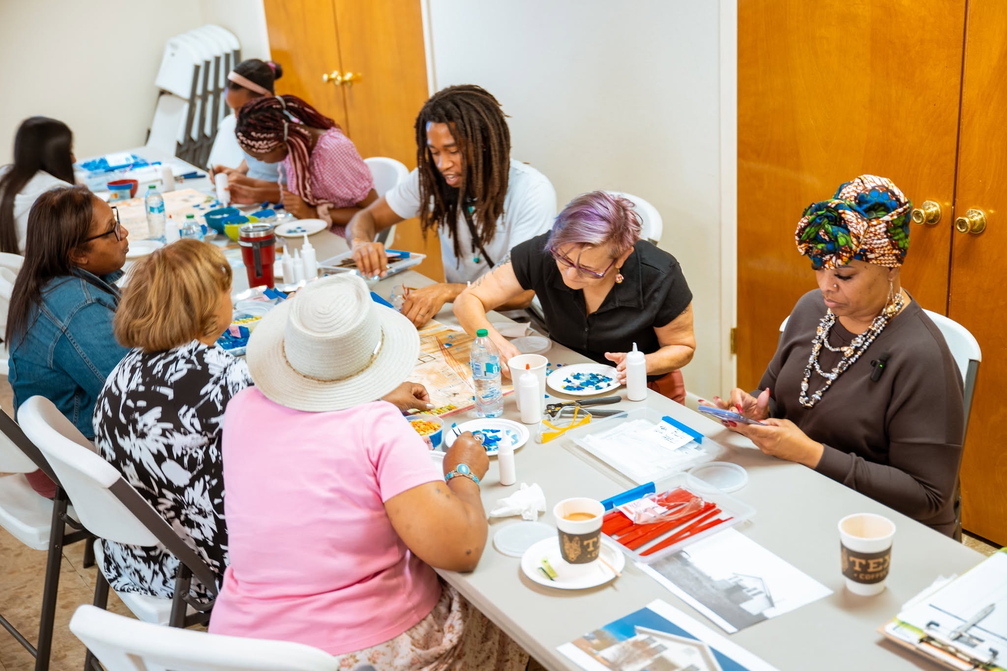 Adults crafting together at community table