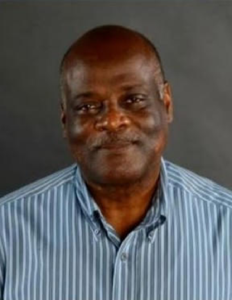 Smiling bald person wearing blue striped shirt