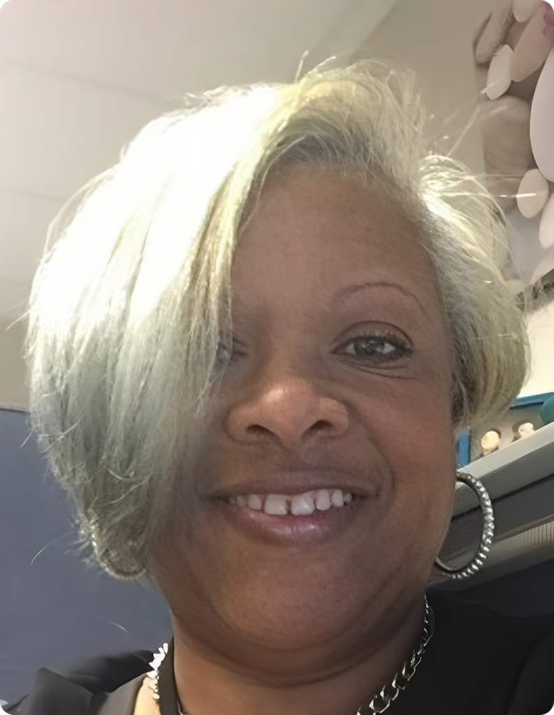 Smiling person with short silver hair