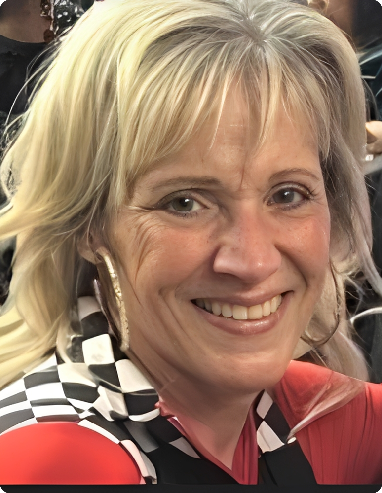 Smiling woman in checkered racing outfit