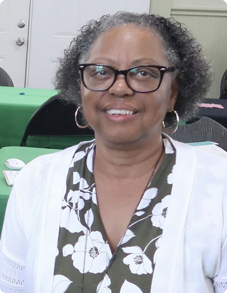 Smiling woman wearing glasses and floral blouse
